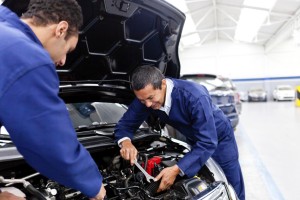 Mechanics fixing a car